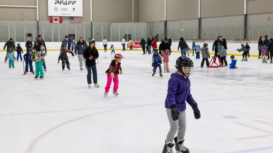 People skating on an indoor ice rink