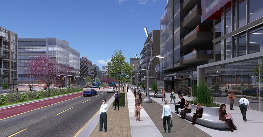 Urban street with pedestrians, modern buildings, and a blue sky.