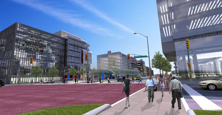 Modern city street with pedestrians, buildings, and traffic lights under a blue sky.