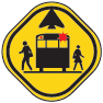 Yellow warning sign with pedestrians by a bus stop.